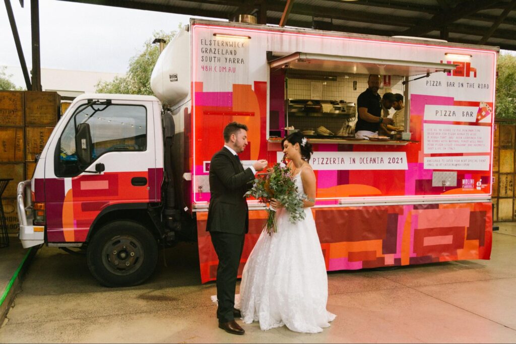 A couple in front of mobile catering truck